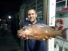 Brandon with a monster mangrove snapper caught night anchor fishing on the Catch My Drift.jpg